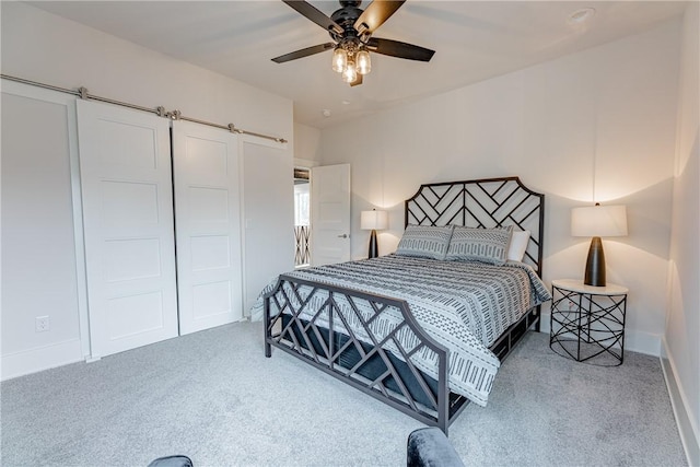 carpeted bedroom with baseboards and a ceiling fan