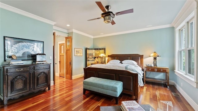 bedroom with wood finished floors, baseboards, ornamental molding, ceiling fan, and recessed lighting
