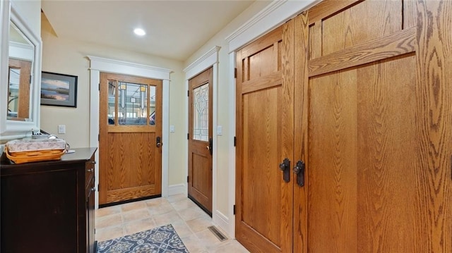 entrance foyer with baseboards, light tile patterned floors, and recessed lighting