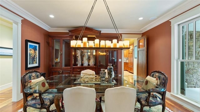 dining area with ornamental molding, wood finished floors, recessed lighting, and baseboards