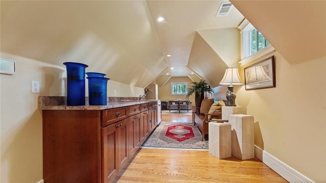 bonus room featuring plenty of natural light, light wood finished floors, lofted ceiling, baseboards, and recessed lighting