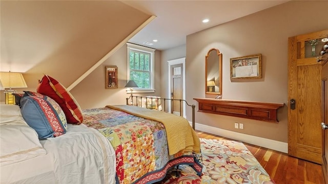bedroom featuring wood finished floors, recessed lighting, and baseboards