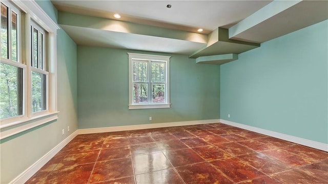 tiled empty room featuring baseboards and recessed lighting