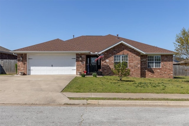 ranch-style home with a front yard, an attached garage, fence, brick siding, and driveway