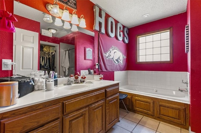 bathroom featuring vanity, tile patterned flooring, a textured ceiling, a bath, and a shower