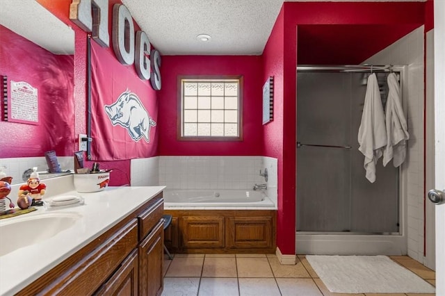 bathroom featuring a shower stall, a textured ceiling, a bath, vanity, and tile patterned floors