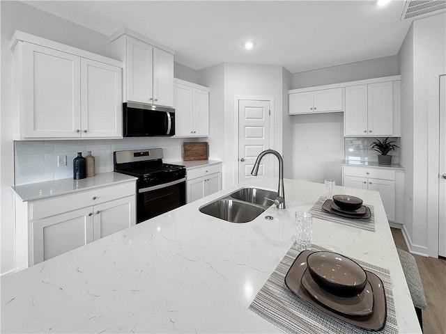 1963 Larkspur St, Springdale, AR 72762 - kitchen with appliances with stainless steel finishes, light stone countertops, tasteful backsplash, white cabinets, and recessed lighting