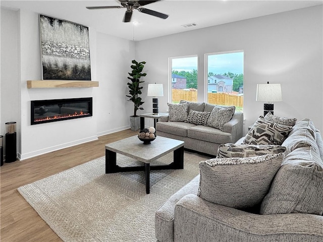 1963 Larkspur St, Springdale, AR 72762 - living area featuring wood finished floors, ceiling fan, and a glass covered fireplace