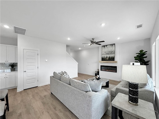 1963 Larkspur St, Springdale, AR 72762 - living area featuring a ceiling fan, recessed lighting, light wood-style floors, and a glass covered fireplace