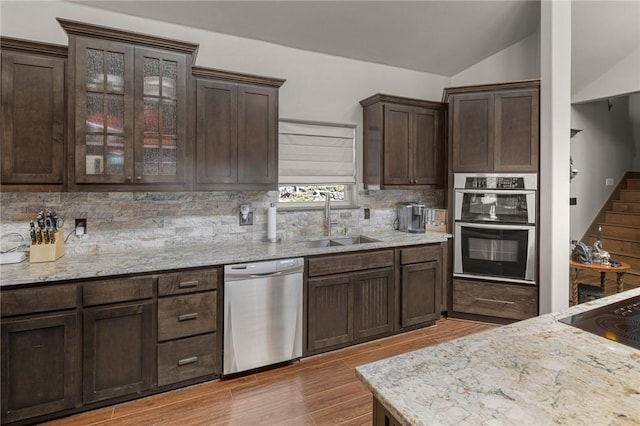 21413 Lakeview Dr, Garfield, AR 72732 - kitchen with dark brown cabinets, vaulted ceiling, appliances with stainless steel finishes, a sink, and decorative backsplash