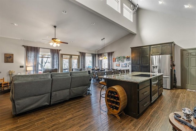 21413 Lakeview Dr, Garfield, AR 72732 - kitchen with stainless steel refrigerator with ice dispenser, dark wood-style floors, a breakfast bar area, and ceiling fan