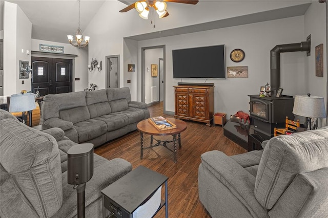 21413 Lakeview Dr, Garfield, AR 72732 - living room featuring ceiling fan with notable chandelier, a wood stove, dark wood finished floors, and high vaulted ceiling