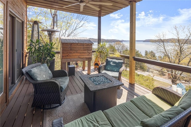 21413 Lakeview Dr, Garfield, AR 72732 - wooden terrace featuring a water view, an outdoor living space with a fire pit, and ceiling fan