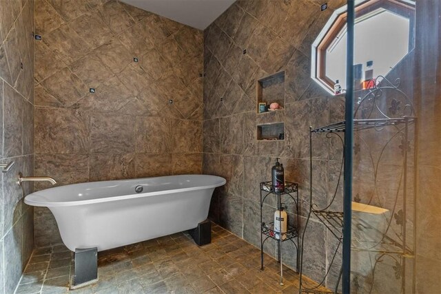 21413 Lakeview Dr, Garfield, AR 72732 - bathroom featuring a freestanding tub, tile walls, and walk in shower