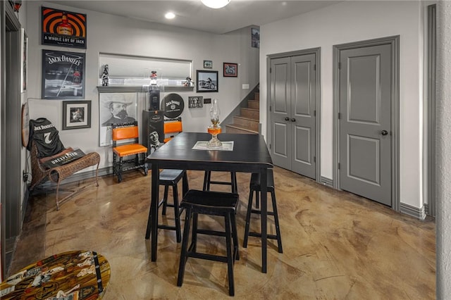 21413 Lakeview Dr, Garfield, AR 72732 - dining space with concrete flooring, baseboards, and stairway