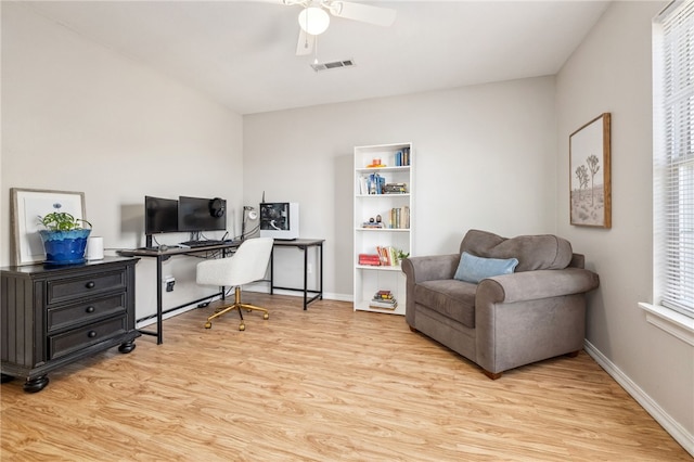 office area with wood finished floors, ceiling fan, baseboards, and visible vents