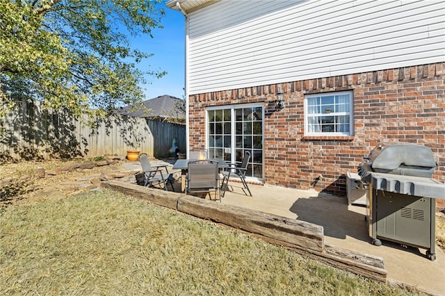view of patio / terrace featuring grilling area and fence
