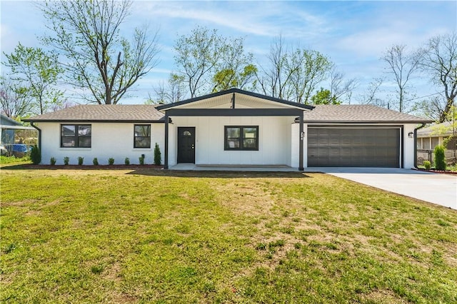 view of front of property featuring a front yard, an attached garage, and concrete driveway
