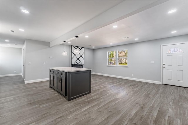 kitchen with open floor plan, baseboards, and wood finished floors