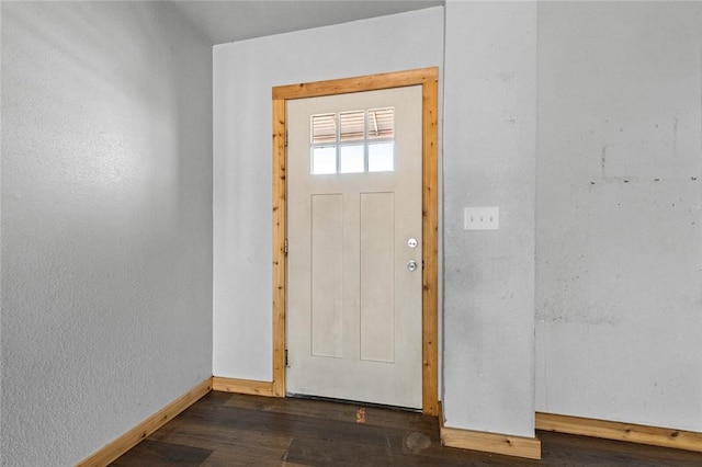 foyer entrance featuring dark wood-style floors and baseboards