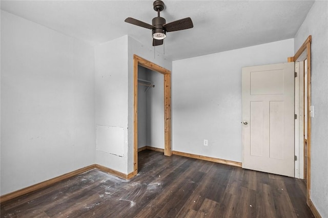 unfurnished bedroom with a closet, hardwood / wood-style flooring, baseboards, and a ceiling fan