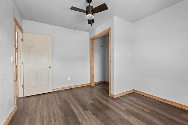 unfurnished bedroom featuring a ceiling fan, a closet, baseboards, and dark wood finished floors