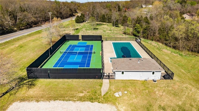 birds eye view of property with a view of trees