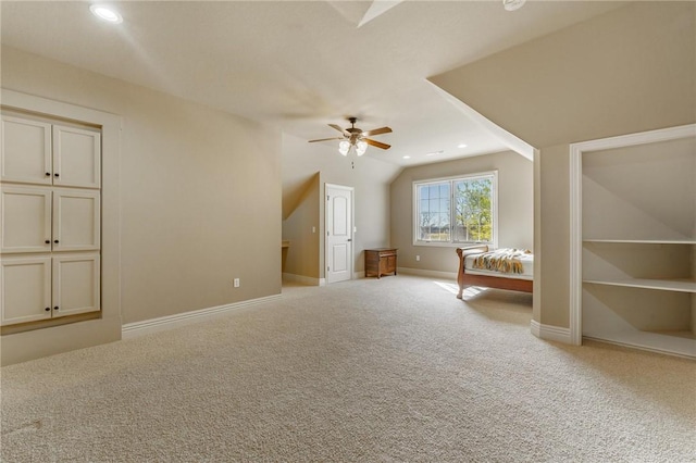 unfurnished bedroom featuring baseboards, recessed lighting, carpet floors, lofted ceiling, and ceiling fan