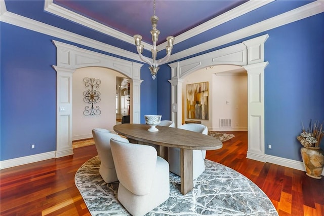 dining area featuring decorative columns, arched walkways, visible vents, and wood finished floors