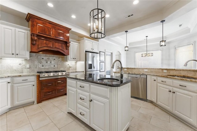 kitchen with appliances with stainless steel finishes, an inviting chandelier, and a sink