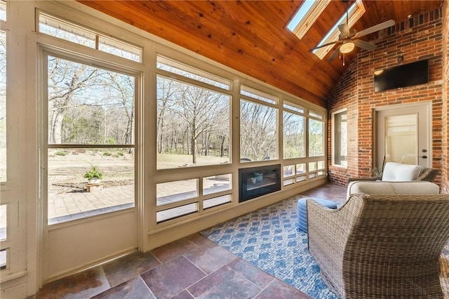 sunroom featuring ceiling fan and a skylight
