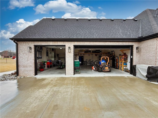 garage featuring concrete driveway