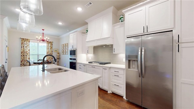 kitchen with white cabinets, appliances with stainless steel finishes, a sink, and visible vents