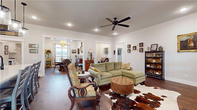 living area with recessed lighting, ornamental molding, a ceiling fan, and dark wood finished floors