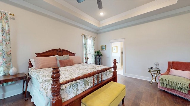bedroom featuring baseboards, recessed lighting, a raised ceiling, and wood finished floors