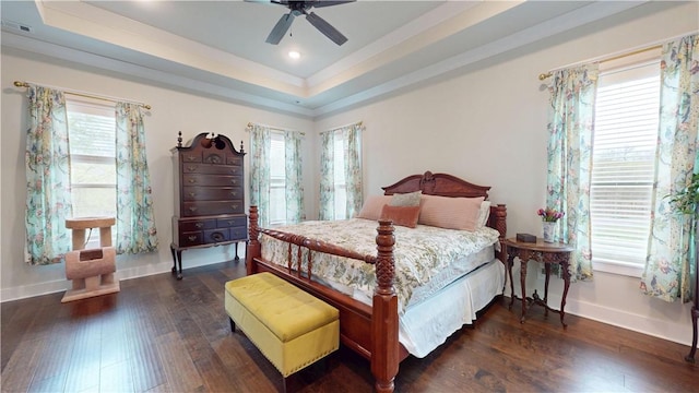 bedroom with ceiling fan, wood finished floors, baseboards, a tray ceiling, and recessed lighting