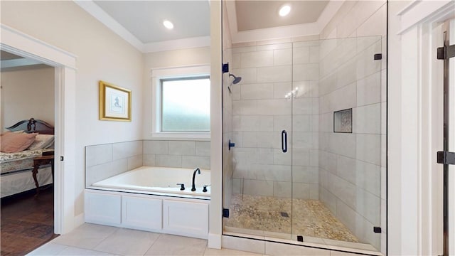 ensuite bathroom with tile patterned flooring, ornamental molding, connected bathroom, a bath, and a shower stall