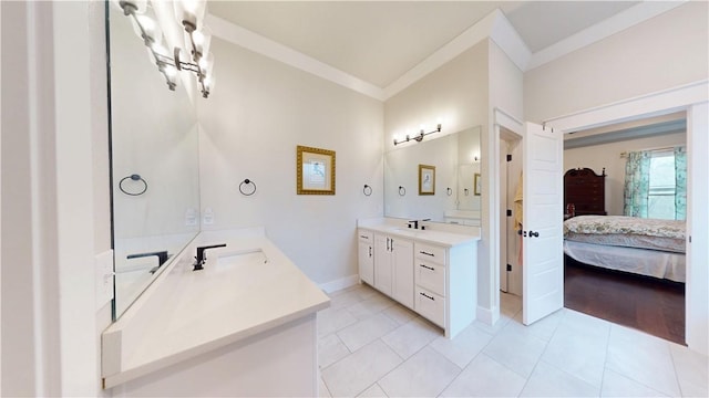 bathroom with two vanities, a sink, tile patterned floors, ornamental molding, and ensuite bathroom