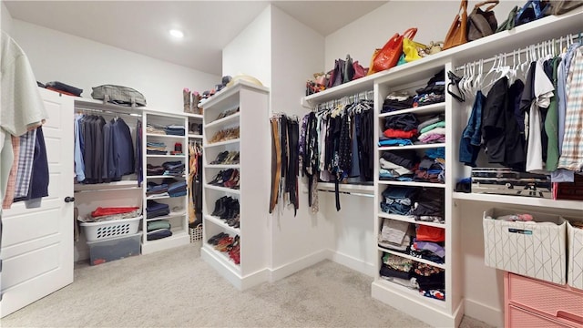 walk in closet with carpet floors