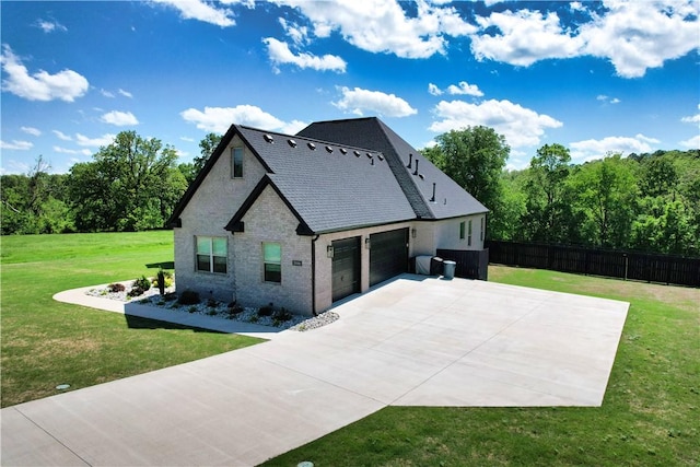 view of home's exterior featuring fence, an attached garage, brick siding, concrete driveway, and a lawn