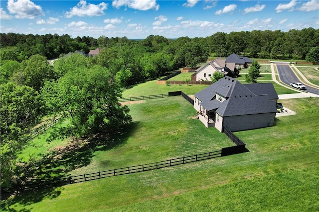 birds eye view of property featuring a view of trees and a rural view