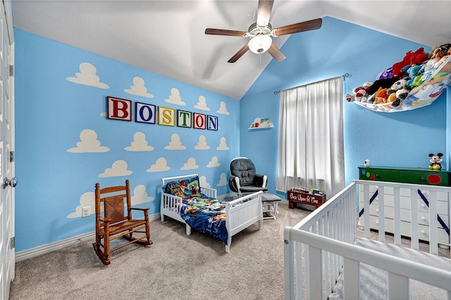 carpeted bedroom with a ceiling fan and vaulted ceiling