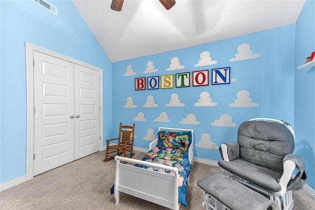 carpeted bedroom featuring lofted ceiling, a closet, visible vents, ceiling fan, and baseboards