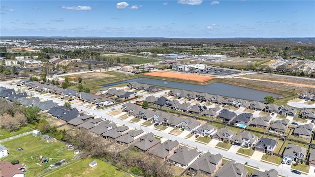 drone / aerial view featuring a water view and a residential view