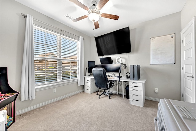 carpeted home office featuring ceiling fan, baseboards, and visible vents
