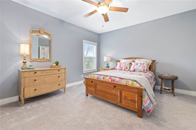 bedroom with light carpet, baseboards, and a ceiling fan