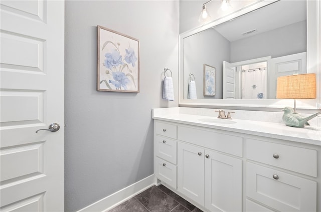 full bathroom featuring vanity, baseboards, and visible vents