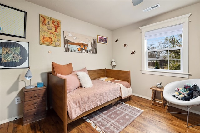 708 NW B St, Bentonville, AR 72712 - bedroom with baseboards, wood finished floors, and visible vents