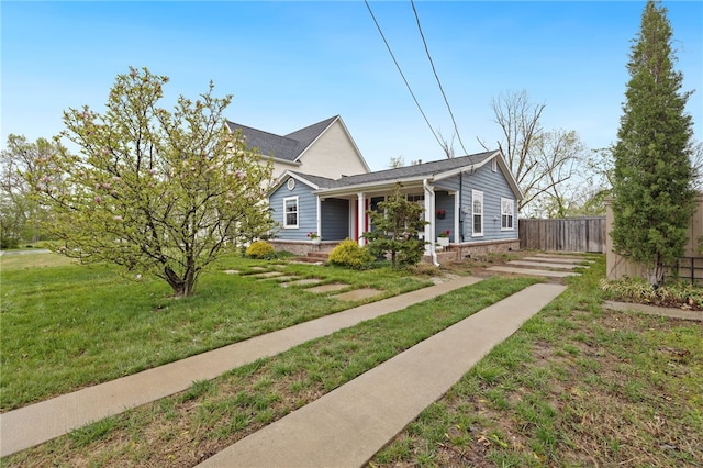 708 NW B St, Bentonville, AR 72712 - bungalow-style house with a front lawn, fence, and covered porch