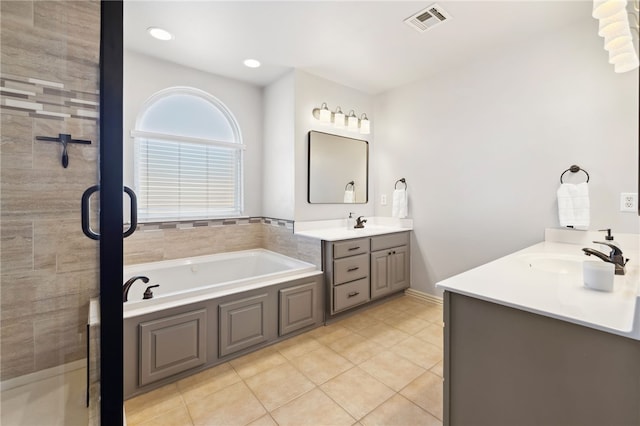 bathroom with a sink, visible vents, tile patterned floors, a stall shower, and two vanities